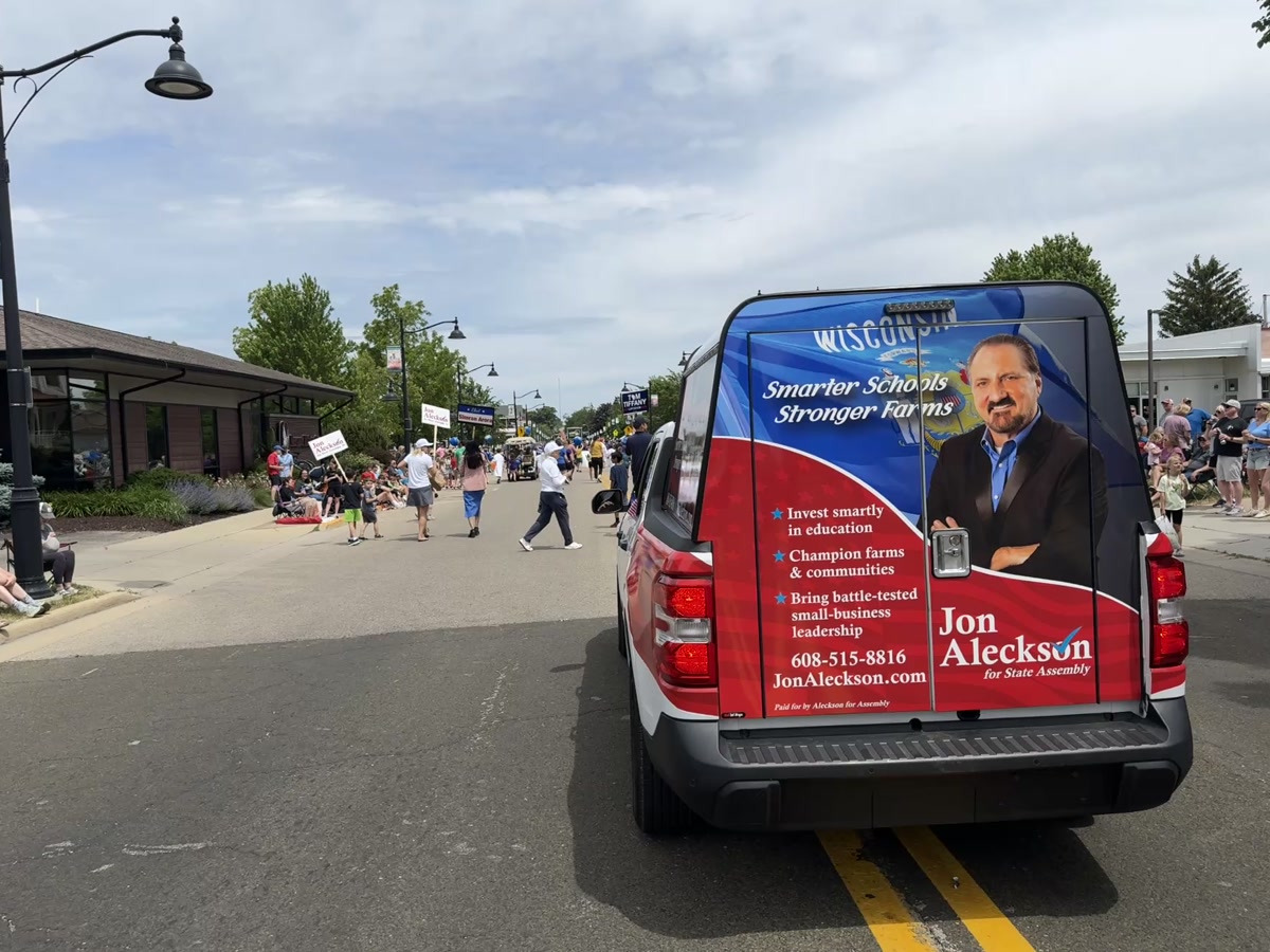 Jon Aleckson campaign van with Smarter Schools, Stronger Farms signage in a community parade