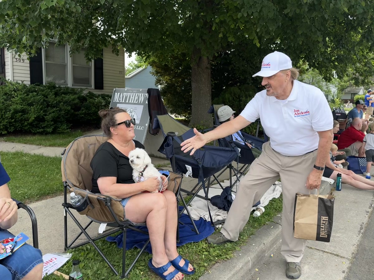 Jon Aleckson shaking hands with a voter at a parade
