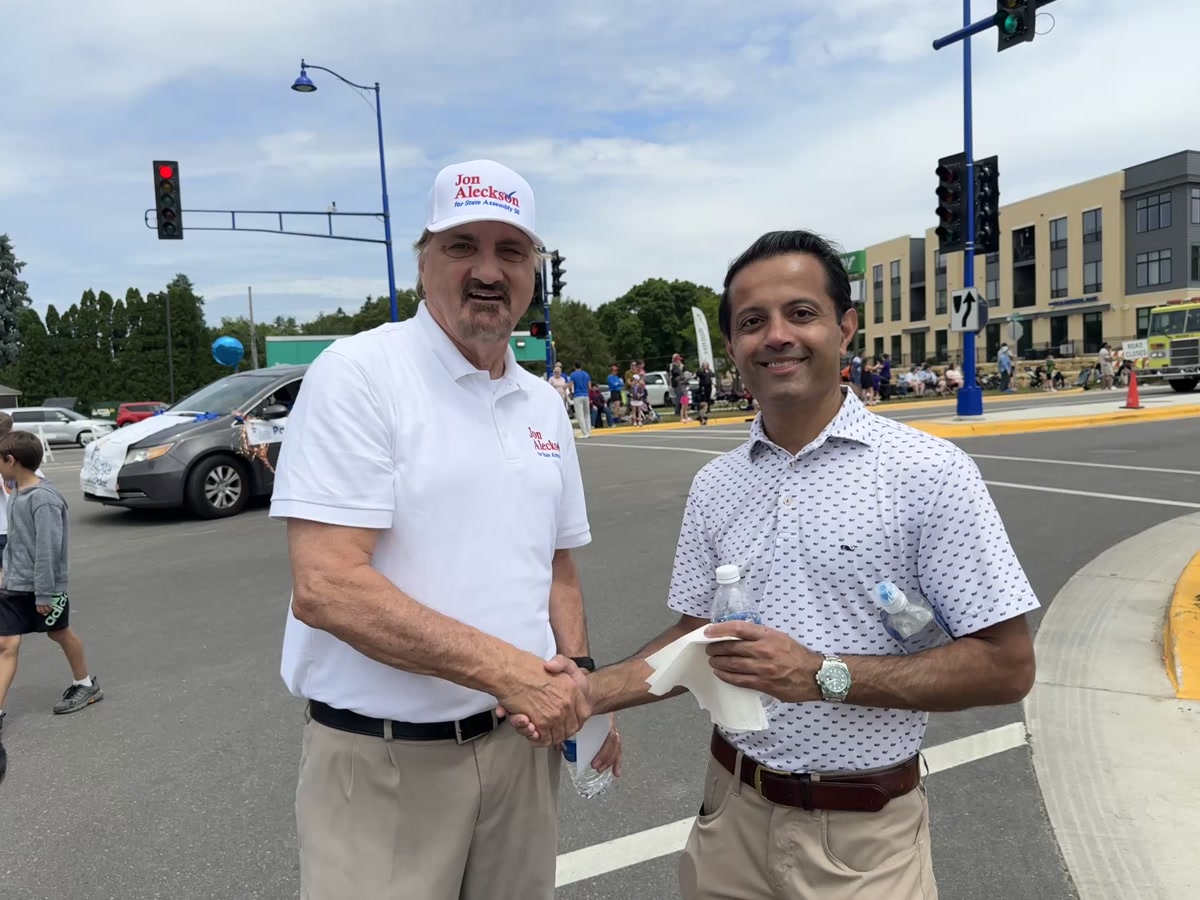 Jon Aleckson shaking hands with a voter at a Main Street parade