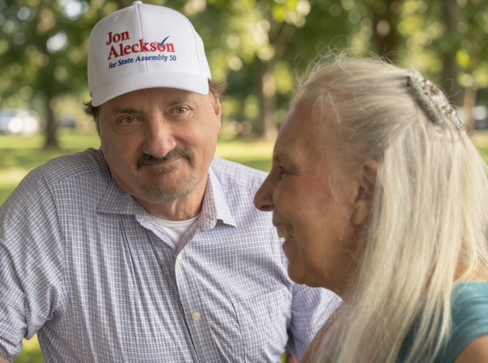Jon Aleckson speaking with a senior citizen